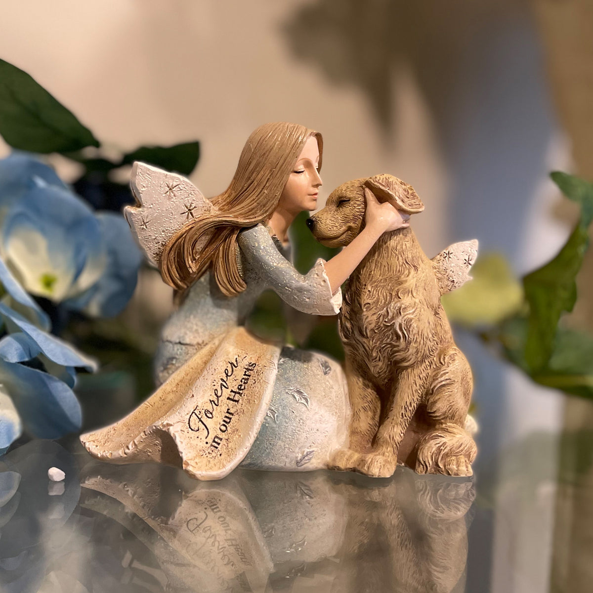 Angel holding clearance dog figurine